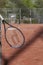 A tennis racket hanging on a steel fence