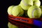 Tennis racket and pile of tennis balls