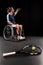 Tennis racquet with ball and disabled sportsman taking selfie behind