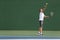 Tennis serve player man serving ball during match point on outdoor green court. Athlete playing sport game training