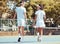 Tennis, sport and teamwork with friends walking on a sports court outside in summer. Fitness, exercise and training with