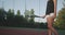 Tennis time on the evening , closeup woman muscle legs , beats the tennis ball with racket at tennis court.