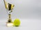 A tennis trophy and tennis ball composition