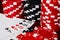Tens Full of aces in a close-up macro image of a winning full house hand surrounded by stacks of Black and Red Poker betting chips
