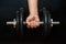 Tense male hand holding a dumbbell