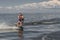 Tense man wakeboarding in a lake and pulled by a boat