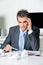 Tensed Businessman Sitting At Desk