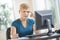 Tensed Businesswoman Working On Desktop PC