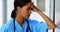 Tensed female doctor standing in corridor