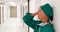 Tensed female surgeon standing in corridor