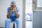 Tensed surgeon sitting with hands on face in corridor