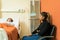 Tensed Woman Sitting By Sick Mother At Hospital