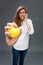 Tensed young beautiful woman grinding her teeth holding an apple