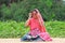 Tension free indian gorgeous woman posing in the garden with a smiling face