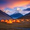 Tent camp and orange tents on the plateau of a mountain the point of acclimatization of climbers before a