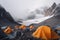 Tent camp and orange tents on the plateau of a mountain valley, the point of acclimatization of climbers before a high