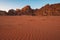 tent camp by the rocks on sunset in the red desert of Wadi Rum in Jordan with patterns on sand