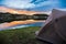 Tent Camping by the Lakeshore at Sunset or Sunrise in the Mountains