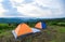 Tent camping on the mountains landscape background - adventure travel camping tent in summer season