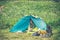 Tent Camping with woman traveler inside and tourism equipment