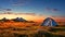 Tent in Field With Setting Sun. Hiking and outdoor recreation