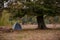 Tent in the forest by the campfire. State of recreation in wild nature. Beautiful moment to go outdoor during fall season