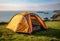 Tent on Grassy Hill Overlooking Ocean