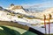 Tent and hiking sticks in snowy mountain landscape. Trekking in Swiss Alps. Hoch Turm, Charetalp, Switzerland.