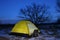 A tent lit up at dusk