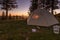 Tent morning in the mountains. Sun gleam through the tent