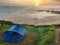 A tent pitched on a coastline next to cliffs at dawn, Way of St. James, Camping La Paz, Vidiago. Llanes municipality. Asturias,