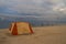 Tent on sandy beach on a background of sea landscape