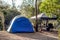 Tent setup with gazebo canopy shelter at the campsite surrounding by nature on the river bank