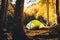 Tent on shore by Bateti lake outdoors in fall in sunny beautiful autumn morning . Relaxation and travel outdoors in fall season