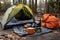 tent, sleeping bag, and camping stove setup
