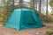 Tent for spending night and traveling green forest stands in Norway
