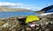 A tent stanging in rocky mountain peaks and glacier in Norway