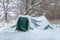 Tent in the winter forest after snowfall