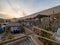 Tents at eco camp hostel in Ica desert at sunrise golden hour, sand dune in the horizon and