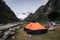 .tents in the foreground in Llamacorral camp with snowy mountains in the background on the trekking of the quebrada santa cruz