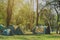 Tents in the forest and green grass.