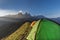 Tents on a mountain edge in front of the Aiguille d\'Arves at sun