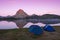 Tents next to the lake of Gentau, Ayous, and the Pico de Midi d`Ossau is reflected in its waters, Pyrenees.