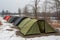 tents and shelters in a row, each with its own design and purpose