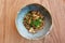 Teppanyaki mushrooms with green leek in earthenware bowl