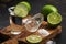 Tequila with lime slice and salt on a cutting board. A drunk stack of tequila is empty on a cutting board. Selective focus