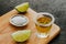 Tequila shot, mexican Alcoholic strong drinks and pieces of lime with salt in mexico