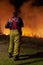 Teralba, NSW/Australia - October 24, 2012: Close up of fireman supervising the backburning and extinguishing a wildfire grass and