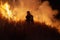 Teralba, NSW/Australia - October 24, 2012: Fireman or firefighter backburning and extinguishing a wildfire grass and bushfire to