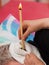 Terapist doing ear candling treatment